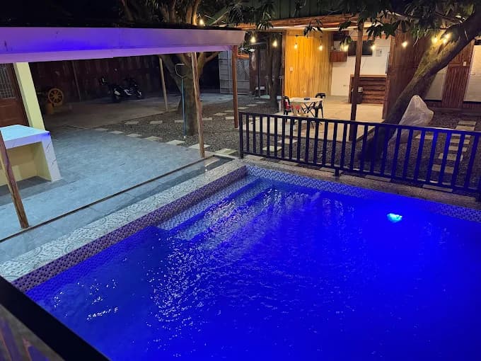 The pool glowing blue at night