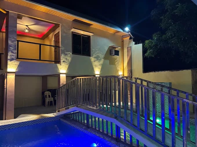 The villa at night with the pool in front