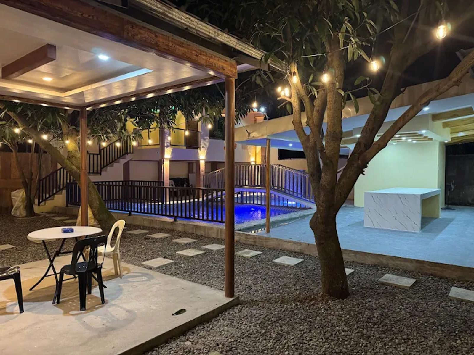 Garden cabanas strung with warm lights under the mango trees at Dela Cruz Place